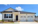 Charming one-story home with a two-car garage, showcasing a modern black and white color scheme at 147 Oakchase Park Ln, Hampton, GA 30228