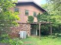 View of backyard with small pergola and brick foundation at 8832 Twin Oaks Dr, Jonesboro, GA 30236