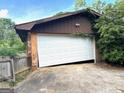 Leaning garage door needs repair or replacement at 8832 Twin Oaks Dr, Jonesboro, GA 30236