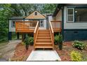 Close-up of the new wooden deck and stairs, enhanced by landscaped mulched beds and green shrubbery at 243 Howell Sw Ter, Atlanta, GA 30331