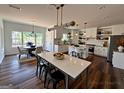 Open kitchen featuring white cabinets, stainless steel appliances, and a center island with bar seating at 2873 Shoals Hill Ct, Dacula, GA 30019