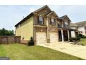 Two-story brick home with attached two-car garage and a well-maintained lawn at 558 Hideaway Dr, Jonesboro, GA 30238