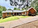 Lovely brick home with a well-maintained lawn, charming landscaping, and a paved driveway at 1000 Turner Church Rd, Mcdonough, GA 30252