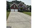 Brick two-story home features a two-car garage and well-maintained front lawn at 3381 Walkers Ridge Rd, Dacula, GA 30019