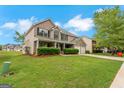 Lovely two-story home featuring a well-kept lawn, attached two-car garage and mature trees at 907 Brisley Cir, Hampton, GA 30228