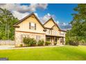 Charming home with stone accents, a well-kept lawn, and mature landscaping at 150 Bellemeade Ct, Fayetteville, GA 30215