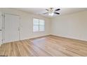 This bedroom features a ceiling fan, laminate flooring, and a private entrance at 4547 Atha Cir, Loganville, GA 30052