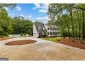 Spacious driveway with view of two story home, pool area and mature landscaping at 607 Lees Mill Rd, Fayetteville, GA 30214