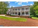Charming home boasting a double porch, black shutters, and lush landscaping at 607 Lees Mill Rd, Fayetteville, GA 30214