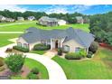 Stunning single-story home featuring an expansive lawn, circular drive and manicured shrubbery at 335 Canvasback Trl, Locust Grove, GA 30248