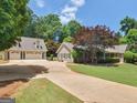 Home exterior and separate garage with a long driveway and well-maintained lawn at 135 Acorn Dr, Mcdonough, GA 30253