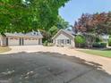 Home exterior and separate garage with a long driveway and well-maintained lawn at 135 Acorn Dr, Mcdonough, GA 30253