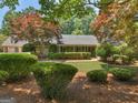 Charming single-story home featuring mature landscaping, a manicured lawn, and lovely curb appeal at 135 Acorn Dr, Mcdonough, GA 30253