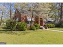 Attractive brick home featuring a well-maintained lawn and mature landscaping in a quiet setting at 109 Stockbridge Rd, Jonesboro, GA 30236
