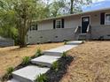 Charming home exterior with a well-manicured walkway and fresh landscaping, offering excellent curb appeal at 1101 White Oak Sw Ave, Atlanta, GA 30310