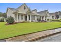 Beautiful home exterior with a lush green lawn, tasteful landscaping, and inviting curb appeal at 1025 Pinehurst Dr, Peachtree City, GA 30269