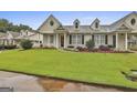 Charming home boasts a well-maintained lawn, beautiful landscaping, and welcoming curb appeal at 1025 Pinehurst Dr, Peachtree City, GA 30269