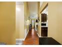 Inviting hallway with hardwood floors leading to the living spaces, featuring a view of the fireplace at 6403 Heritage Run, Morrow, GA 30260