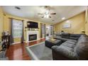 Cozy living room with a fireplace, large sectional sofa, and open access to the dining area and backyard at 6403 Heritage Run, Morrow, GA 30260