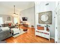 Open-concept living room with stylish decor, fireplace, and hardwood flooring at 329 Royal Crescent Way, Stockbridge, GA 30281