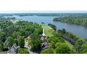 Aerial view of lakefront property featuring a golf course, lake, and lush trees at 513 Viridian Vw, Peachtree City, GA 30269