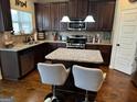 Modern kitchen featuring stainless steel appliances, granite countertops, and a functional center island at 860 Nevis Way, Mcdonough, GA 30253