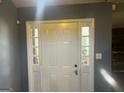 Elegant entryway with a white front door framed by sidelights and neutral-colored walls at 366 Montgomery Pl, Jonesboro, GA 30238