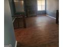 Spacious living room featuring wood-look tile floors, a stone fireplace, and natural light at 366 Montgomery Pl, Jonesboro, GA 30238