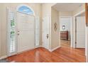 Bright foyer with wood floors, a large front door, and access to other rooms at 412 Rock Creek Dr, Peachtree City, GA 30269