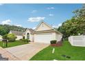 A beautifully landscaped front yard complements this home with an attached two-car garage at 412 Rock Creek Dr, Peachtree City, GA 30269