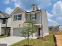 New two-story home with gray siding and brick, showcasing modern design and landscaping at 13 Butternut Way # 120B, Auburn, GA 30011