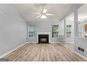 Open-concept living room with fireplace and large windows offering abundant natural light at 520 Lakecourt Dr, Mcdonough, GA 30253