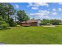 Expansive backyard with a wooden deck, surrounded by mature trees, provides ample outdoor space at 195 Southmoor Cir, Stockbridge, GA 30281