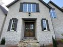 Close-up of an attractive home entrance with stone steps and a stylish double-door entry at 100 Regina Ct, Fayetteville, GA 30215