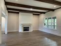 Bright and spacious living room featuring hardwood floors, modern fireplace, and natural light at 100 Regina Ct, Fayetteville, GA 30215