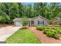 Inviting single-story home with a well-manicured lawn and an attached garage at 810 Bedford Park, Peachtree City, GA 30269