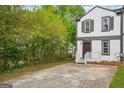 Charming townhome featuring a front yard with a concrete driveway at 2049 Charter Ln, Lithonia, GA 30058