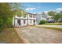 Charming townhome featuring a front yard with a concrete driveway at 2049 Charter Ln, Lithonia, GA 30058