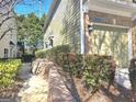 View of the exterior brick and siding of townhome at 2540, featuring a one-car garage and retaining wall landscaping at 2540 Willow Grove Road Nw Rd # 15, Acworth, GA 30101