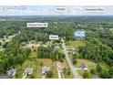 Aerial view showing neighborhood with the home's location, surrounded by mature trees, and nearby amenities at 301 Bradford Ct, Auburn, GA 30011