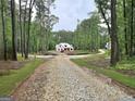 New construction home surrounded by lush greenery and mature trees at 2039 Fischer Rd, Sharpsburg, GA 30277