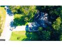 Birds eye view of the home situated on a lot surrounded by mature trees, providing shade and privacy at 8846 Wesley Pl, Jonesboro, GA 30238