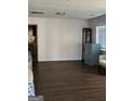 Open living room with dark wood floors and neutral walls, offering ample space for furnishings at 953 South Ave, Forest Park, GA 30297