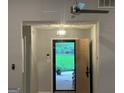 Inviting entryway with a view to the outdoors, features a stylish light fixture and neutral decor at 6884 Shangrila Way, Riverdale, GA 30296