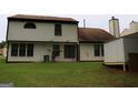 Back exterior of home with a large yard, patio, and a shed on blocks at 3255 Hunters Crossing Pt, Lithonia, GA 30038