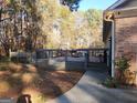 Outdoor deck with railing provides a spacious area for relaxing or entertaining with the natural beauty of surrounding trees at 6340 Koweta Rd, Fairburn, GA 30213