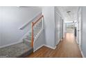 Hallway with hardwood floors, a staircase and a closet and views into the living room at 695 Georgetown Ct, Jonesboro, GA 30236