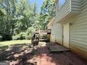 Exterior view of the back of a home with a small wooden deck and steps leading down to the yard at 270 Mountain Way, Covington, GA 30016