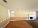 Spacious living room with a fireplace and a combination of carpet and wood flooring, creating a cozy atmosphere at 270 Mountain Way, Covington, GA 30016