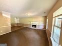 Cozy living room with a fireplace and built-in shelves, offering a warm and inviting atmosphere at 270 Mountain Way, Covington, GA 30016